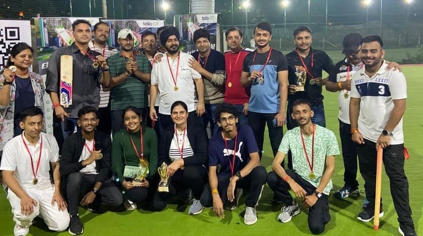 TelioLabs team at a company cricket tournament event, holding trophies and medals